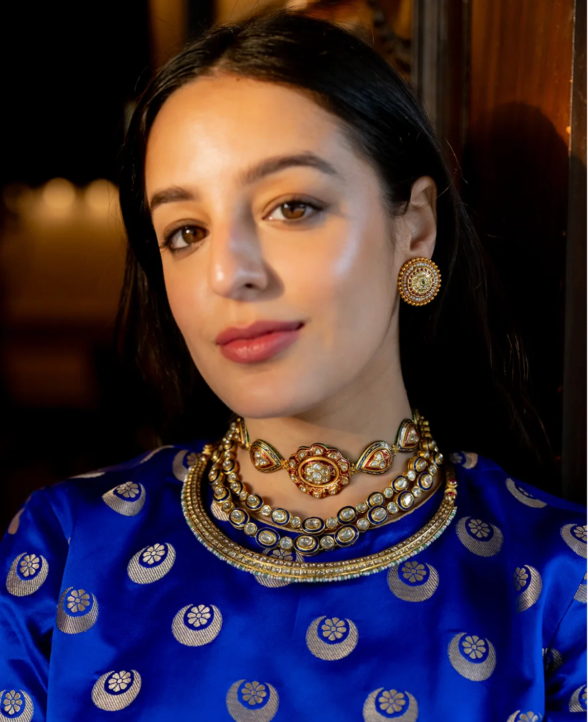 Handcrafted Kalki Full Hasli gold necklace featuring a rigid torque design with kundan-set polki (uncut) diamonds on one side and vibrant meenakari enamel work on the reverse.