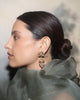 Gold domed jhumka earrings with Navratna gemstones, uncut polki diamonds, red enamel detailing, and cultured pearl fringes