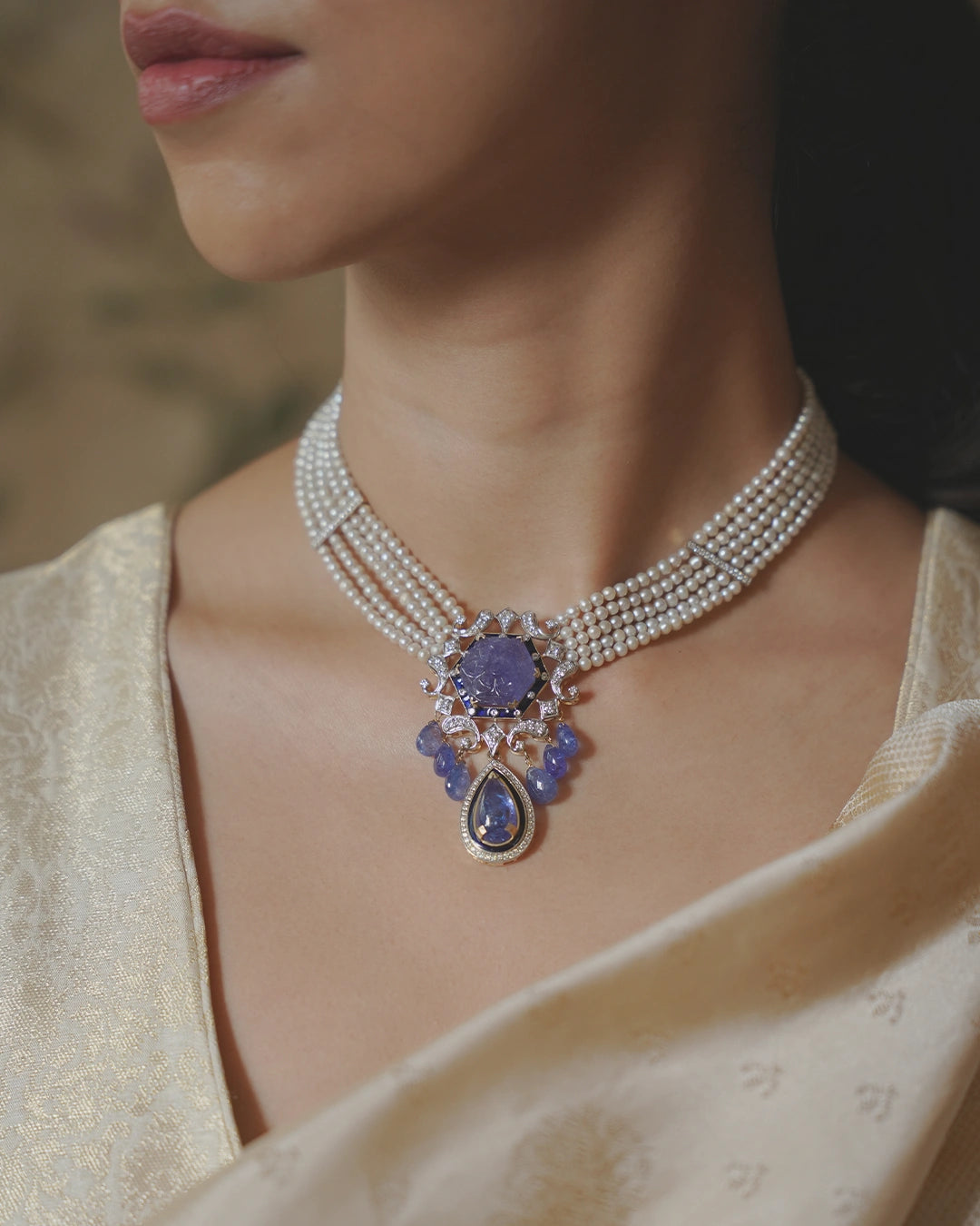 Model wearing the Eza tanzanite necklace with diamonds and cultured pearls