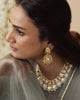 Indus handcrafted gold earrings featuring Polki diamonds, tourmalines, traditional kundan jadai, red meena chudiwork, seed pearls, and green enamel bead fringes.