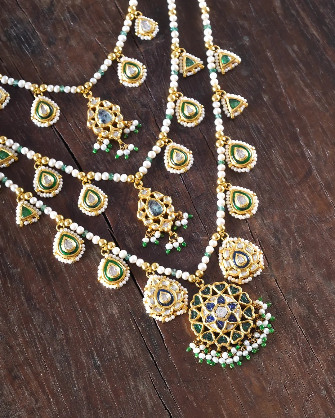Keerat teenlada gold necklace with emeralds pearls and gemstone details