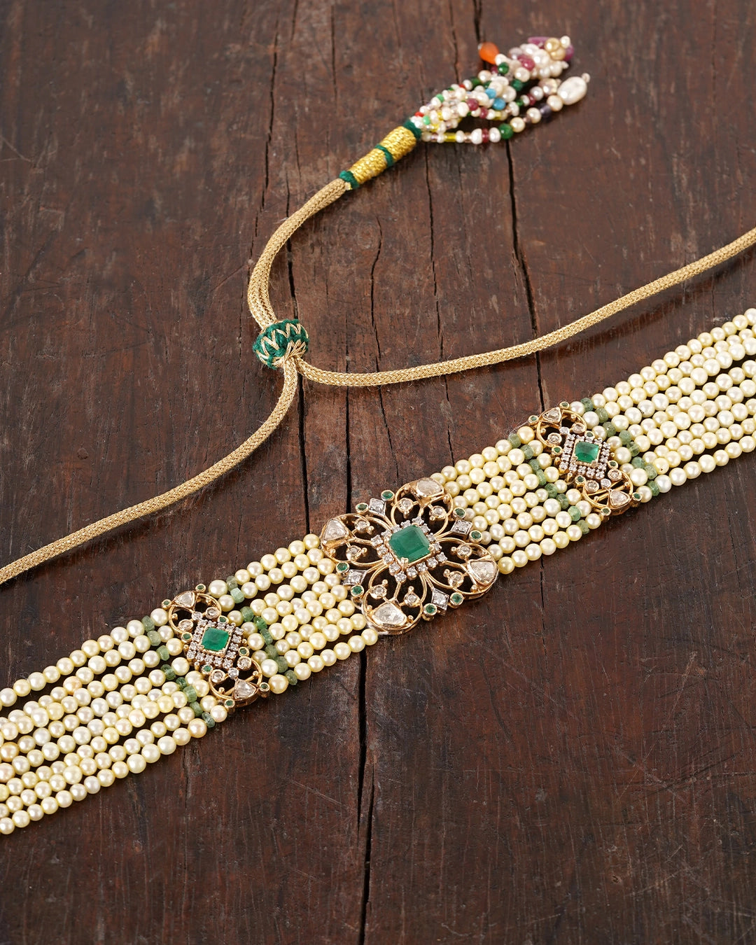 Keira gold bridal choker necklace featuring cultured pearls, natural brilliant-cut and rose-cut diamonds, and a faceted emerald centre, handcrafted using traditional Hyderabadi jewellery techniques.