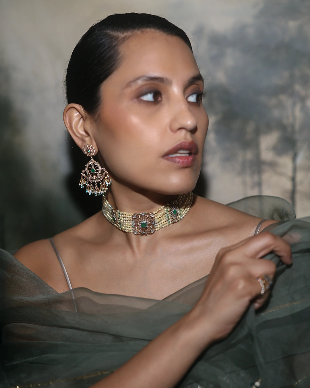 Keira gold bridal choker necklace featuring cultured pearls, natural brilliant-cut and rose-cut diamonds, and a faceted emerald centre, handcrafted using traditional Hyderabadi jewellery techniques.