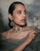 Keira gold bridal choker necklace featuring cultured pearls, natural brilliant-cut and rose-cut diamonds, and a faceted emerald centre, handcrafted using traditional Hyderabadi jewellery techniques.