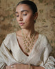 Keerat teenlada gold necklace with emeralds pearls and gemstone details