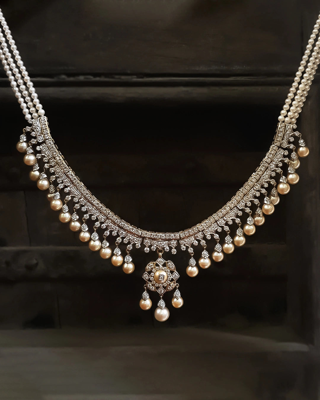 Mukta Necklace in gold featuring a natural brilliant-cut diamond framework with cascading cultured pearl drops and a suspended central pendant
