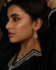 Naaz Earrings worn close-up  gold drop earrings with a rose-cut diamond surrounded by brilliant-cut diamonds, shown against skin.
