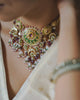 Model wearing the Raag polki necklace with tourmaline emeralds and pearls