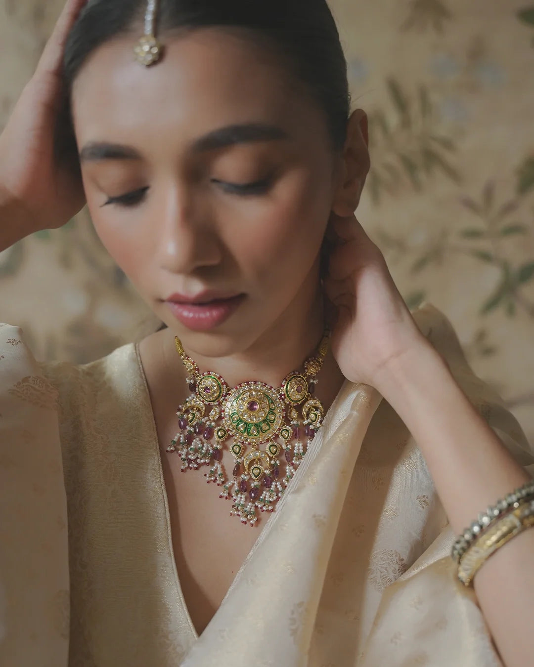 Model wearing the Raag polki necklace with tourmaline emeralds and pearls