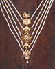 Layered panchlada necklace with pearls, emerald beads, uncut diamonds, and vibrant gemstones set in gold for women.