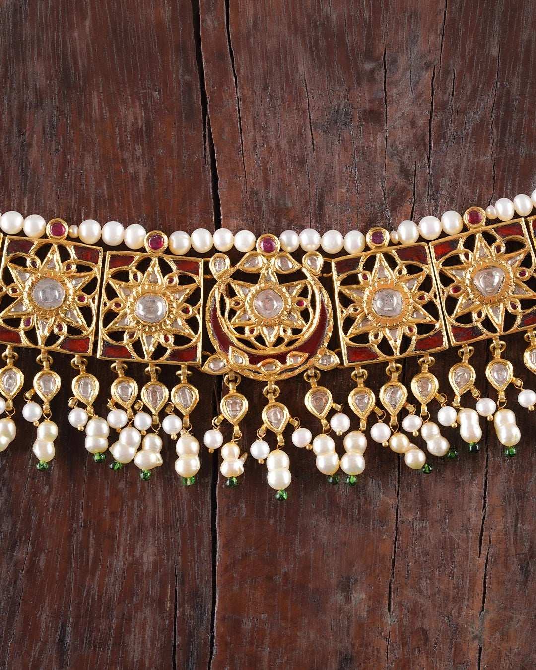 Handcrafted Indian gold bridal choker inspired by the traditional Guluband, featuring a central crescent moon (chaand) and floral (phool) motif with eight square units. Adorned with polki diamonds, kundan-set stones, pearl borders, and pearl-and-polki drop strands, this heirloom bridal necklace blends traditional craftsmanship with timeless elegance.