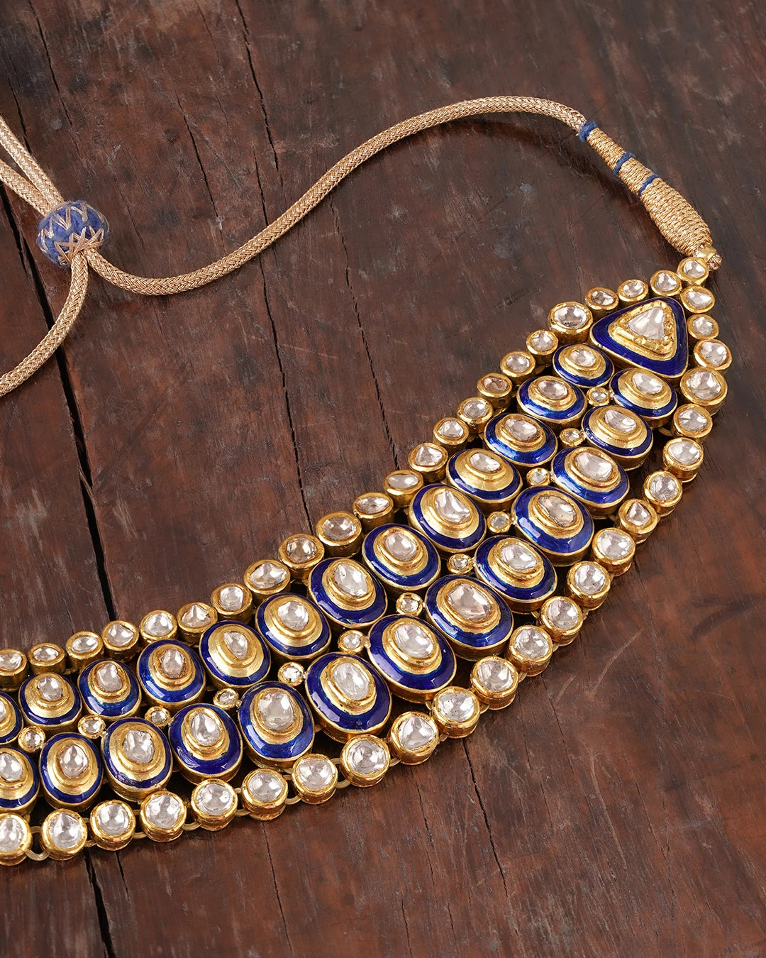 Vivir gold Polki collar necklace with graduated uncut diamonds and cobalt blue enamel borders, worn close to the throat